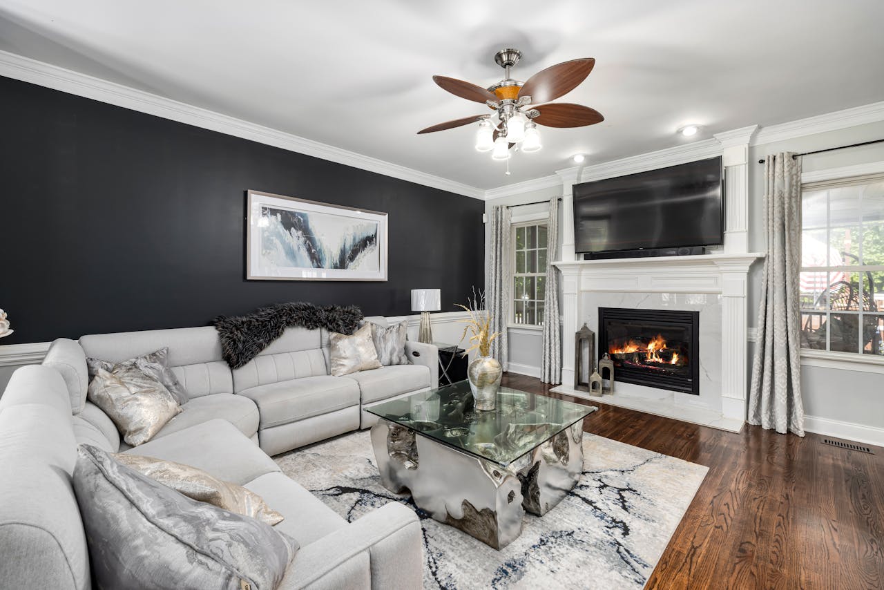 Spacious living room featuring a fireplace, modern decor, and a cozy atmosphere.